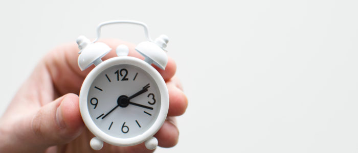 hand holding white clock