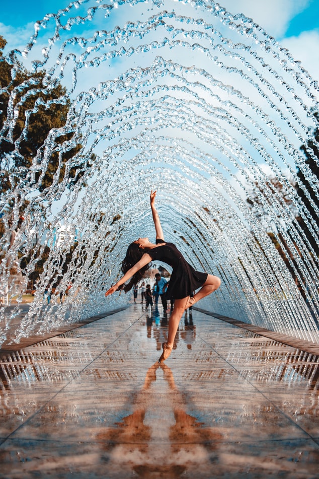 woman dancing near the water fountain